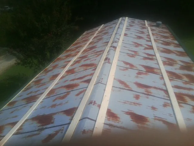 Rusted metal roof panels with new wood purlins before replacement — Storm Damage Roof Repair in Westminster by Roofing Brothers